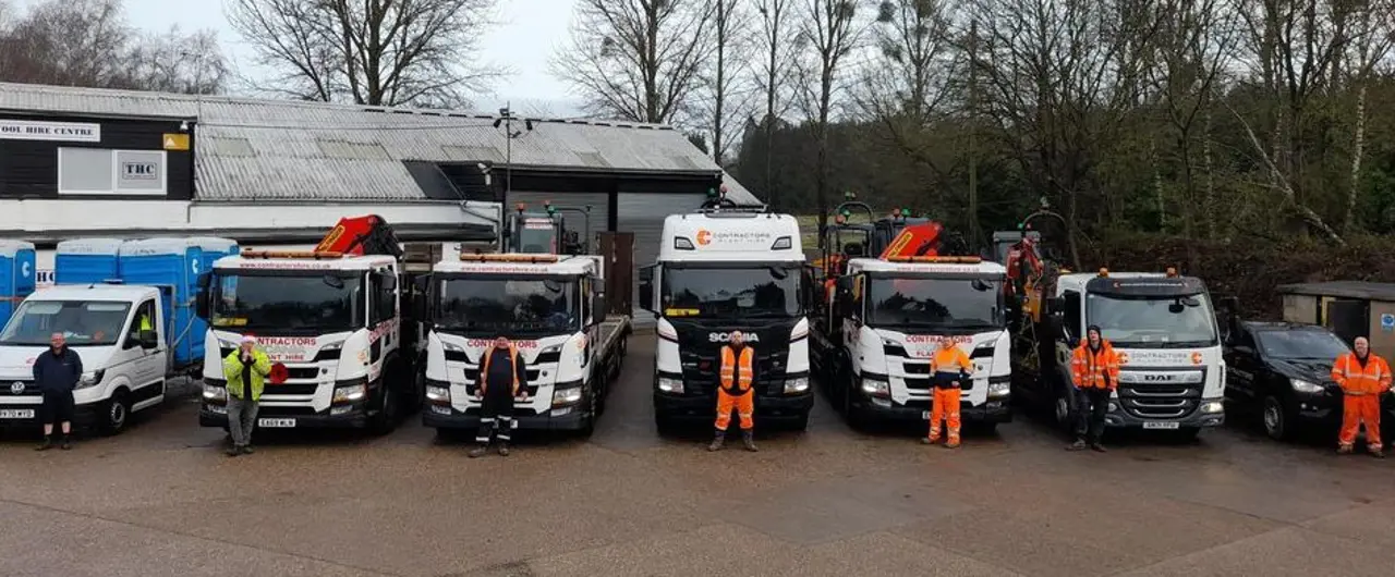 Workers Standing Infront Of Lorries